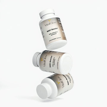 Three bottles of Vital Glow NAD+ Booster on a white background