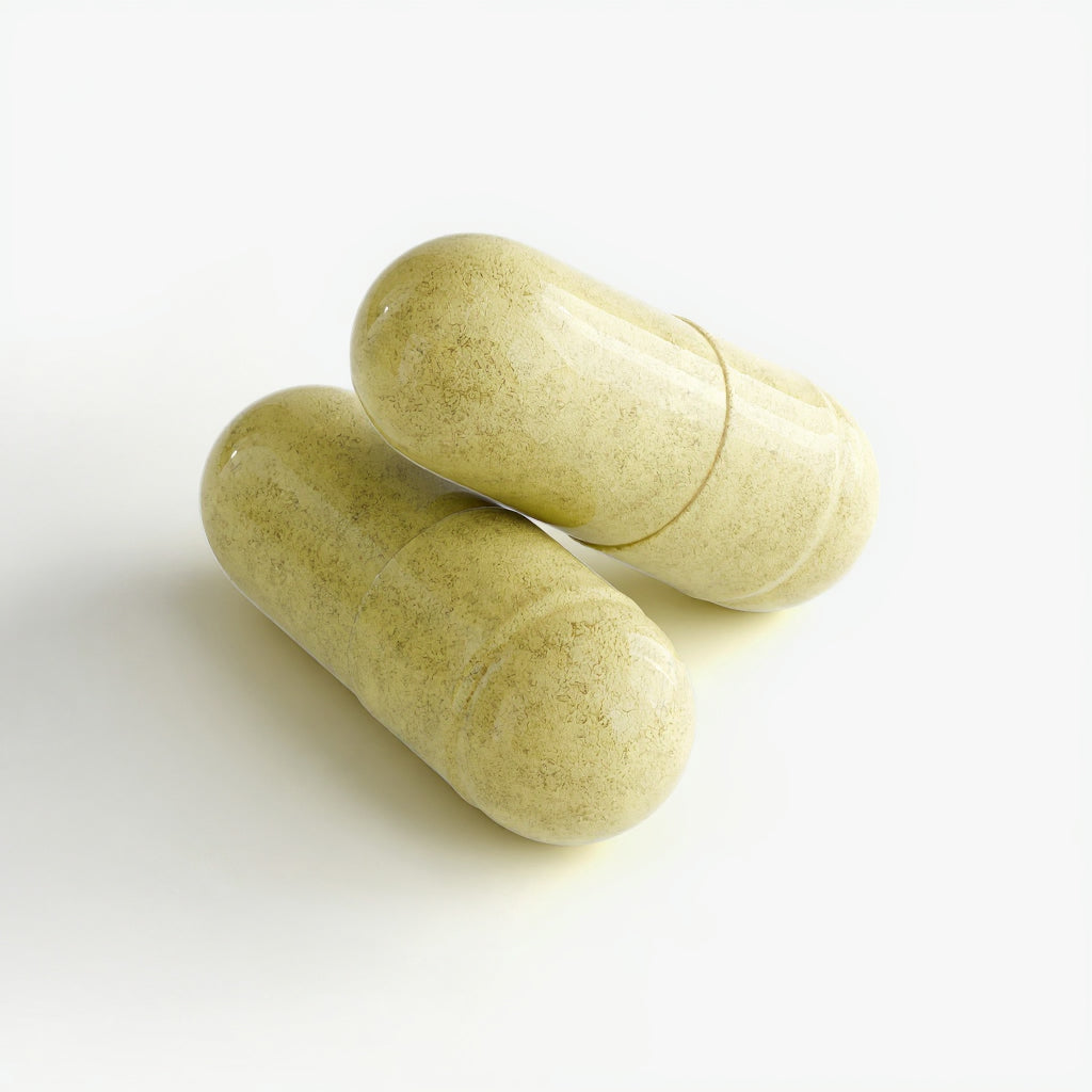 Two green capsules on a white background