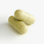 Two green capsules on a white background