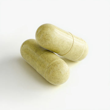 Two green capsules on a white background